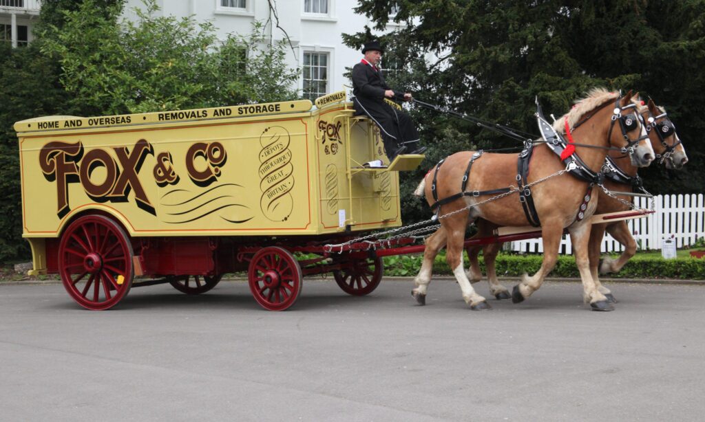 a horse drawn vintage fox & co removals vehicle