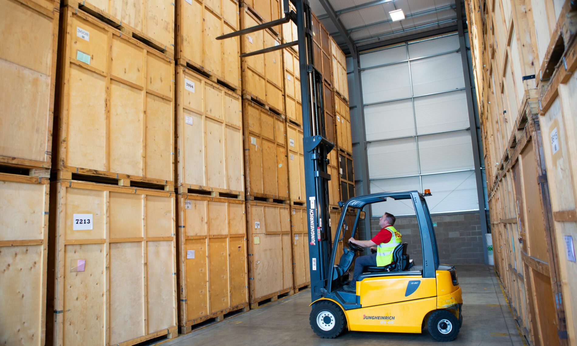 fox removals expert moving wooden containers in a fox facility