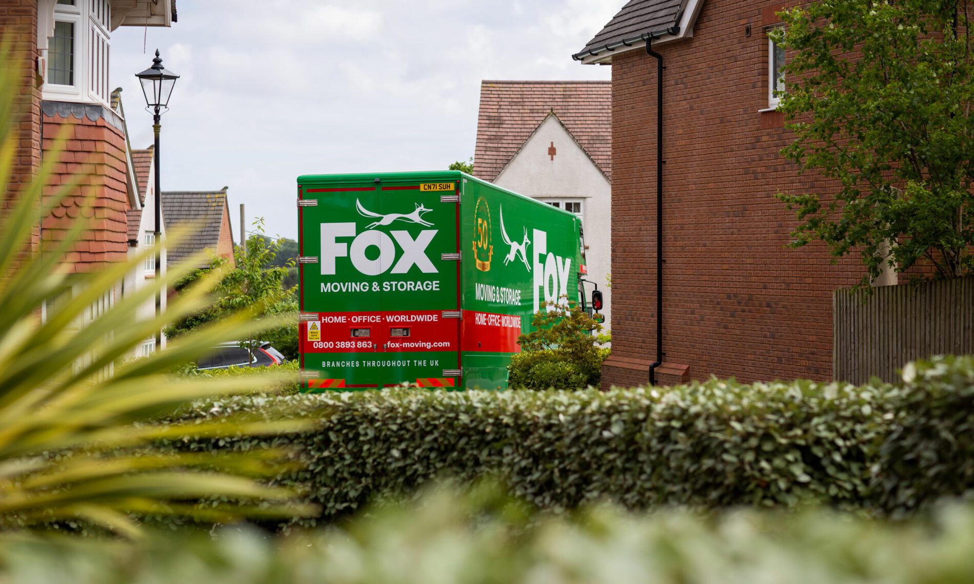 fox moving and storage van outside a house