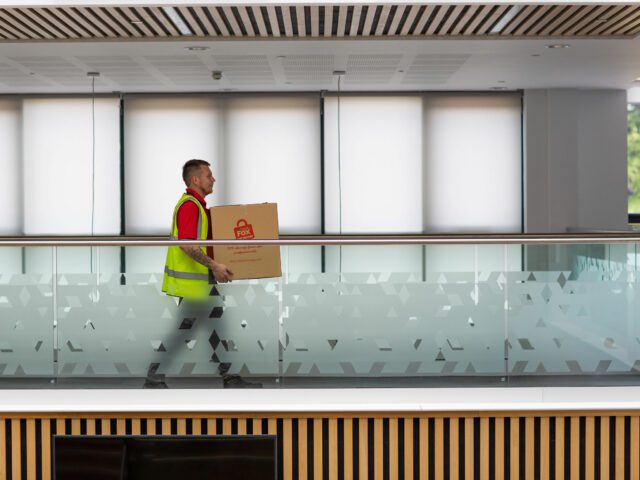 fox removals expert moving boxes during an office clearance