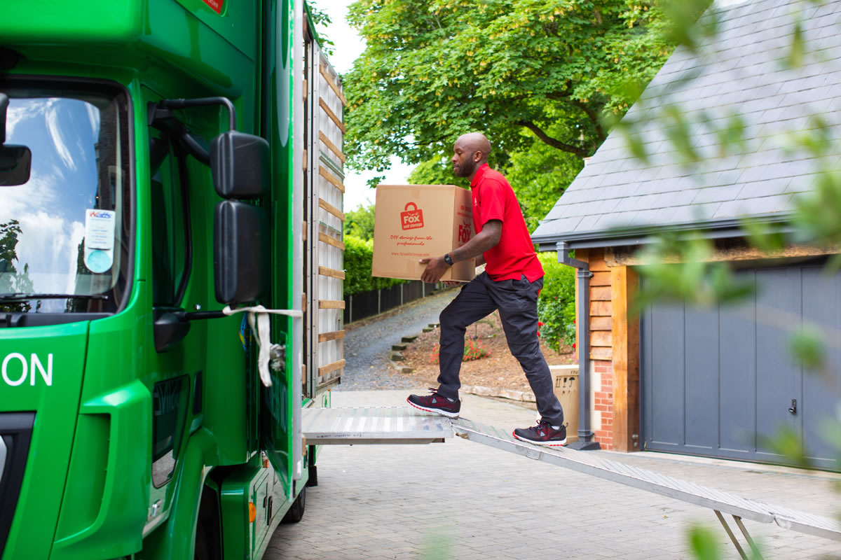 fox removals expert moving boxes into a fox van