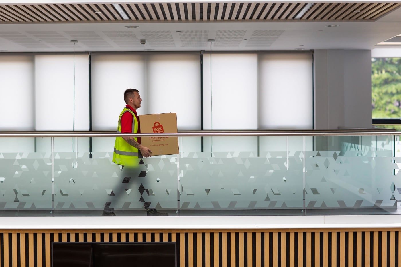 fox moving and storage mover carrying a box as part of a commercial move